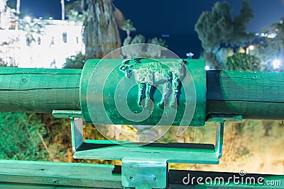 Sign of the zodiac Capricorn on the bridge of the Wishing Bridge in the green light of a spotlight located on old city Yafo in Tel Editorial Stock Photo