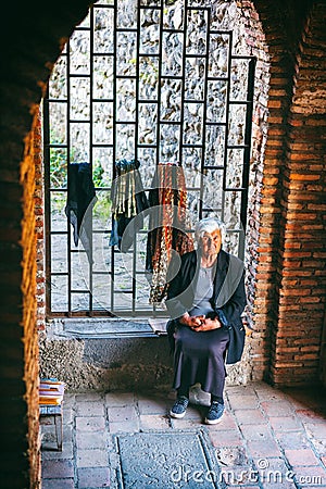 Woman female vendor sells souvenirin Sighnaghi town fortress, Kakheti region, Georgia Editorial Stock Photo