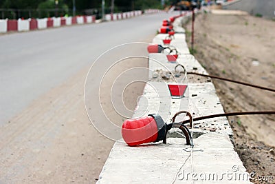 Signal lights on the fundamental blocks of concrete, fencing construction the viaduct from the existing road. Stock Photo