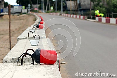 Signal lights on the fundamental blocks of concrete, fencing construction the viaduct from the existing road. Stock Photo