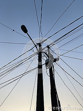 electric pole with tangled wires Stock Photo