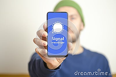 Signal messenger app. Smartphone screen with messenger app Signal in hand Editorial Stock Photo
