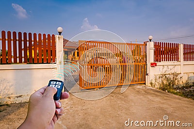 A signal of remote control show when person open automatic gate at home,motor automatic gate Stock Photo