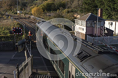 Signalman handing a key to train driver for travel on a single rail track Editorial Stock Photo