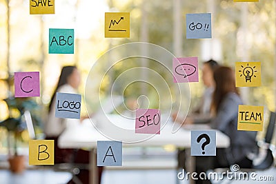 Signboard with the idea paper attached on with a soft background of businesspeople sitting on a chair. Positive idea, Stock Photo