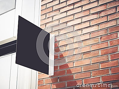 Signboard shop Mock up Black metal sign display on brick wall Stock Photo