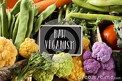 Raw vegetables and text raw veganism Stock Photo