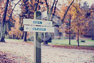 Signboard with two signs saying - Open - Closed Stock Photo