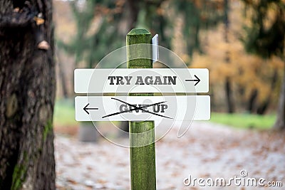 Signboard with two signs saying - Try again - Give up - pointing Stock Photo