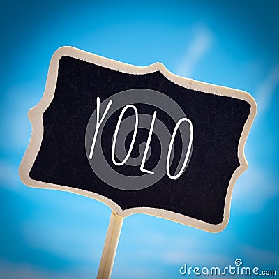 Signboard with the word yolo, vignetted Stock Photo