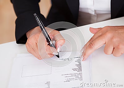Signing a document Stock Photo