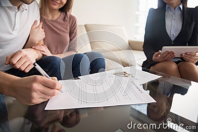 Signing of rental agreement, couple meeting with real estate age Stock Photo
