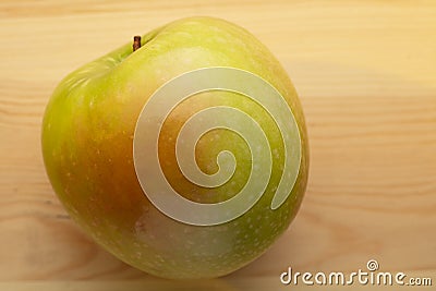 Signle green apple on a wooden background Stock Photo