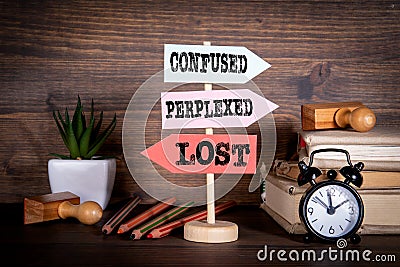 Signpost with arrows - Confused, Perplexed and Lost Stock Photo