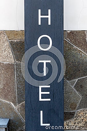 Signpost HOTEL near the facade of the entrance group of the building, Close-up, vertical Stock Photo