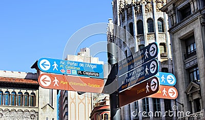 Signpost with information arrows for city guests and tourists in Barcelona street Editorial Stock Photo