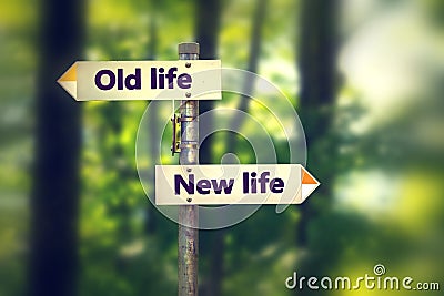 Signpost in a park with arrows old and new life pointing in two opposite directions Stock Photo