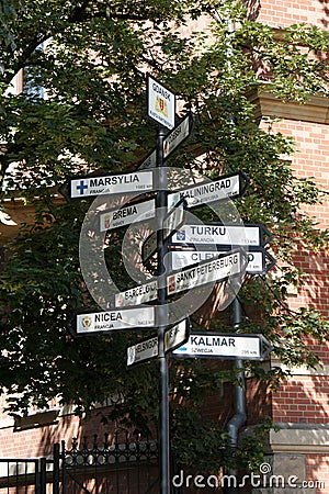 Signpost sign road sign indicates many directions Stock Photo