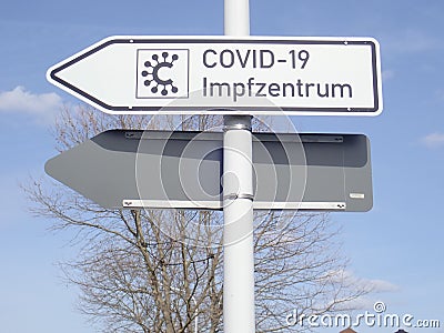 Signpost to a COVID-19 Vaccination Center in Germany Editorial Stock Photo