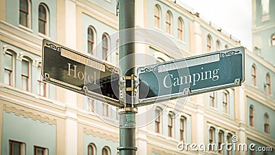Signposts the direct way to Camping versus Hotel Stock Photo