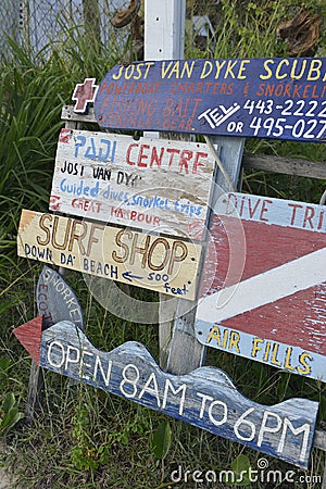 Signs advertising scuba diving and the surf shop, Great Harbour, Jost Van Dyke, BVI Editorial Stock Photo