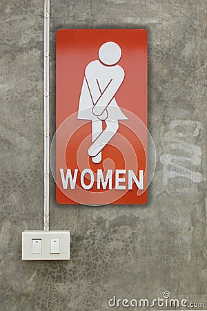 Signs female bathroom and light switch was on the wall. Stock Photo