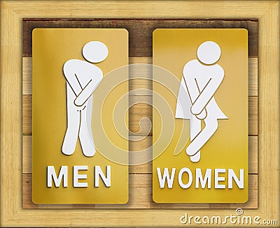 Signs female and male bathroom on wooden background. Stock Photo