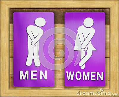 Signs female and male bathroom on wooden background. Stock Photo