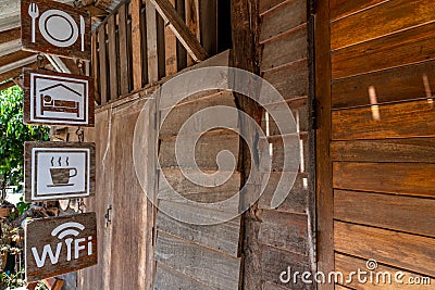 Signs hanging in front of an old wooden home stay. Stock Photo