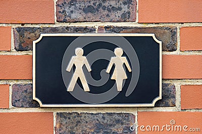SignShowing Male And Female Figures Outside Public Toilet To Illustrate Gender Issues Stock Photo