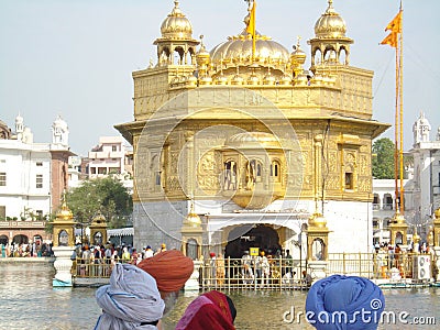 Sikh people looking at the Golden Temple Editorial Stock Photo