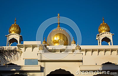 Sikh temple golden domes gleam in the sun Stock Photo