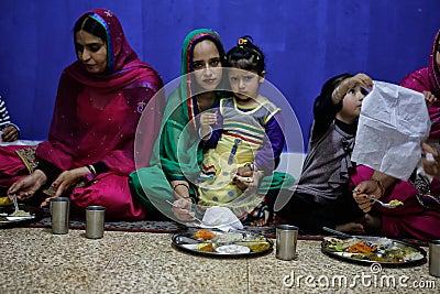 Sikh woman and daughter during dinner Editorial Stock Photo