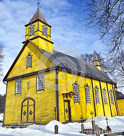 Silenai old wooden yellow church, Vilnius district, Lithuania Stock Photo