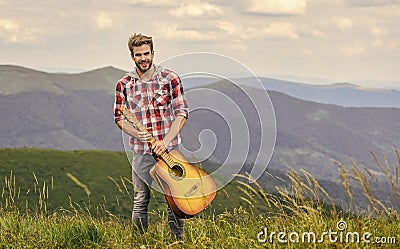 Silence of mountains and sound of guitar strings. Hipster musician. Inspiring environment. Summer music festival Stock Photo