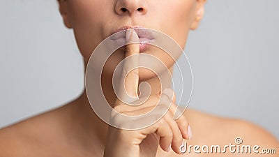 Silent gesture. Woman holding finger on lips Stock Photo