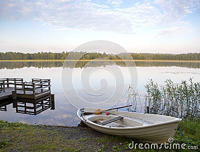 Silent morning at the lake with rowing boat. Stock Photo