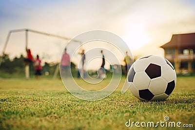 Silhouette action sport outdoors of a group of kids having fun playing soccer football for exercise in community under Stock Photo