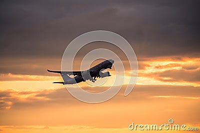 Silhouette of airplane at sunset. Editorial Stock Photo