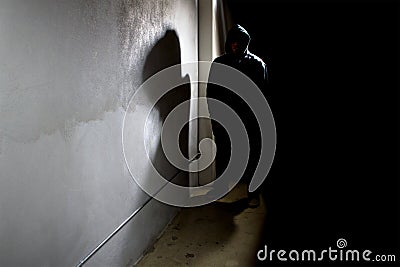 Silhouette of an Alley Stalking Criminal Stock Photo