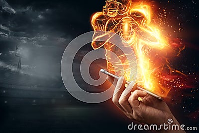 A silhouette of an American football player on fire crawls out of a smartphone. Online sports concept, speed, bet, american game Stock Photo