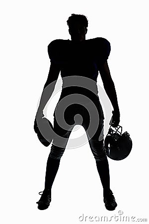 Silhouette American football player holding ball and helmet Stock Photo