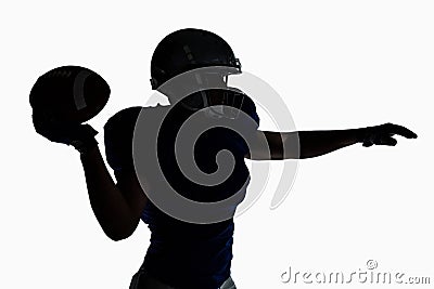 Silhouette American football player throwing ball Stock Photo