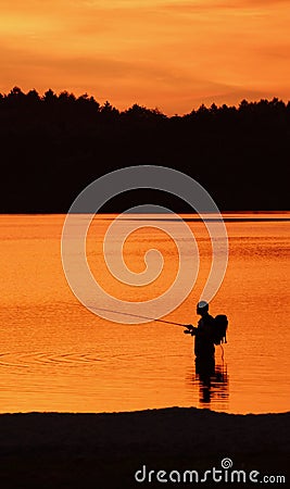 Silhouette of the angler in the lake Stock Photo