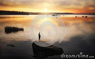 Silhouette of angler on sunset. Sun reflecting in water with stones and islands. Baltic sea, gulf of Finland Stock Photo