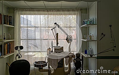 Silhouette of an antique dentist`s chair in front of a bright window near Bishop, California, USA - November 6, 2022 Editorial Stock Photo