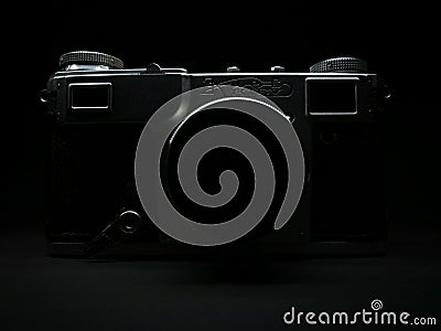 Silhouette of antique obsolete russian or soviet professional dslr camera with film from ussr, retro photography equipment in Editorial Stock Photo