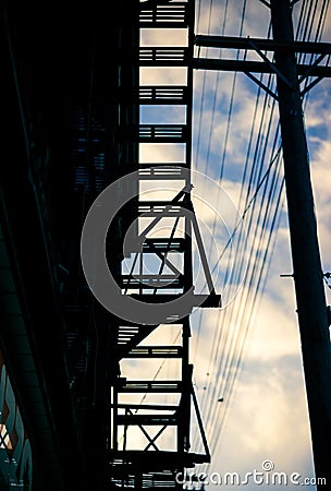 The silhouette of an apartment building`s fire escape Stock Photo