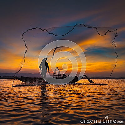 Silhouette of asian fisherman on wooden boat in action Stock Photo