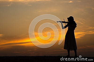 Silhouette of asian woman play violin Stock Photo